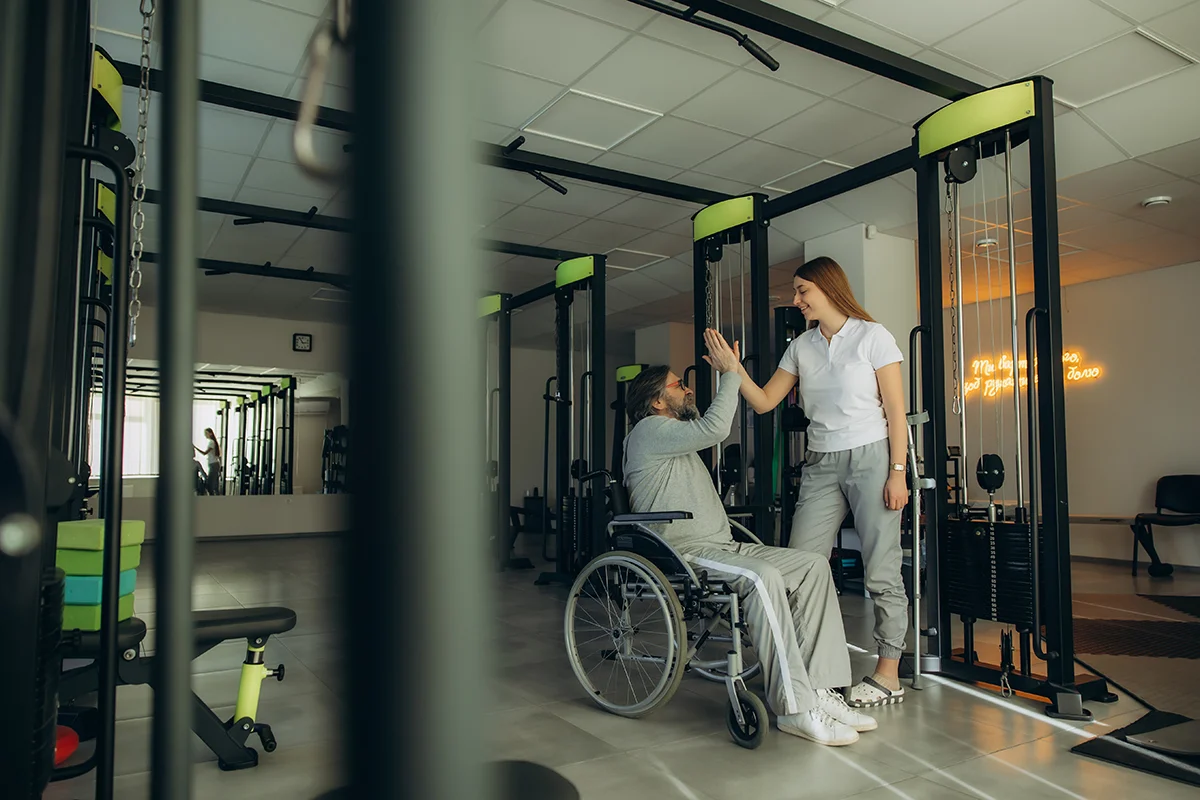 physiotherapist and man in wheelchair high