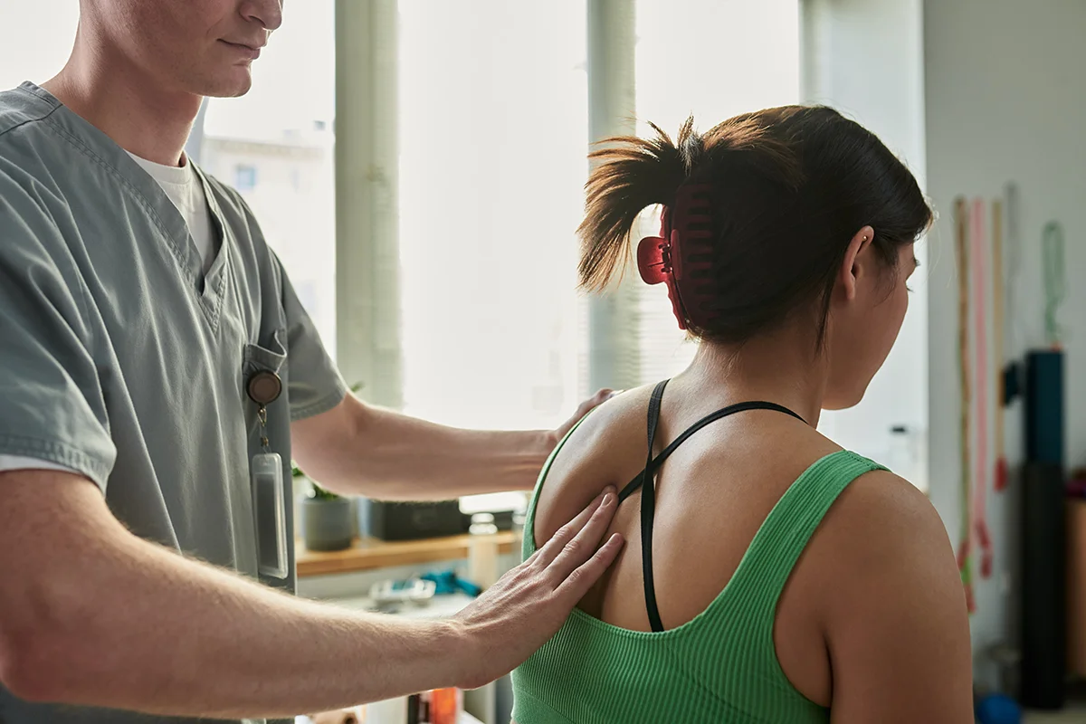 physiotherapist helping patient
